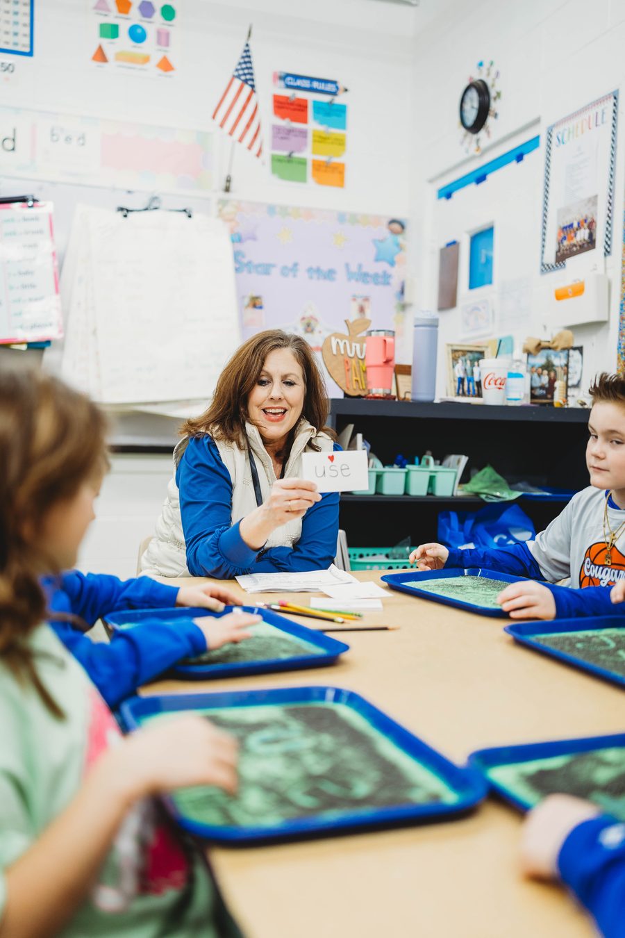 A Columbia Academy teacher working with young students in class