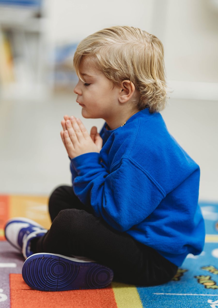 A young Columbia Academy student praying